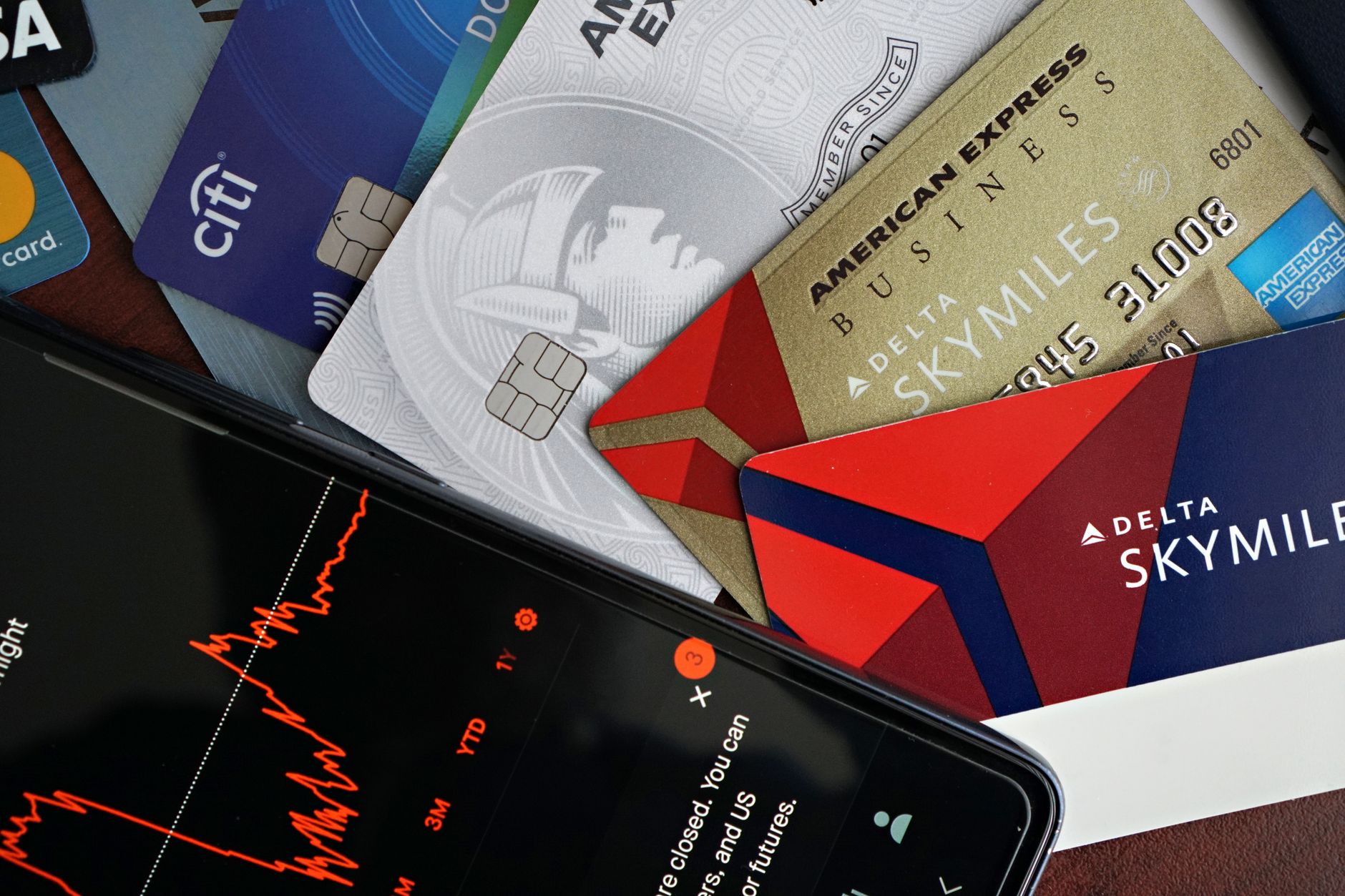 Credit cards and financial market graph on a smartphone